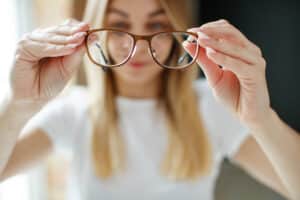 Girl Holding Eye Glasses